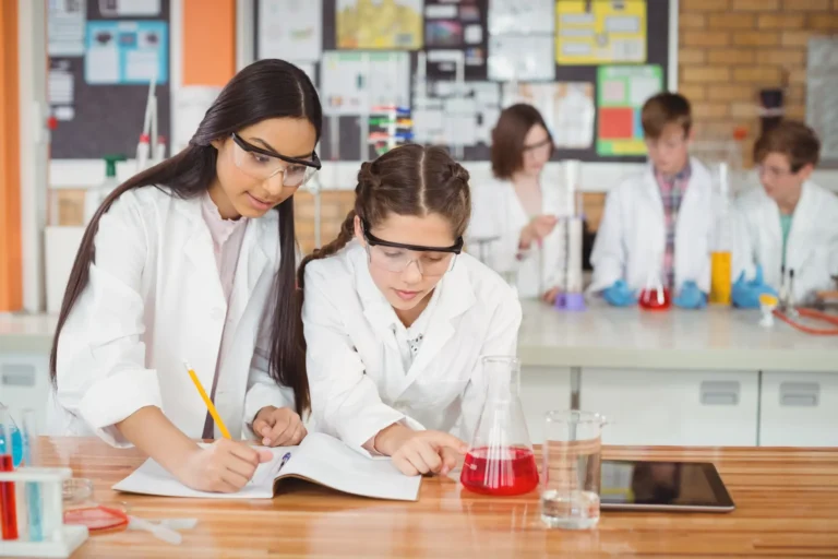 school-girls-writing-journal-book-while-experimenting-laboratory-school (2)